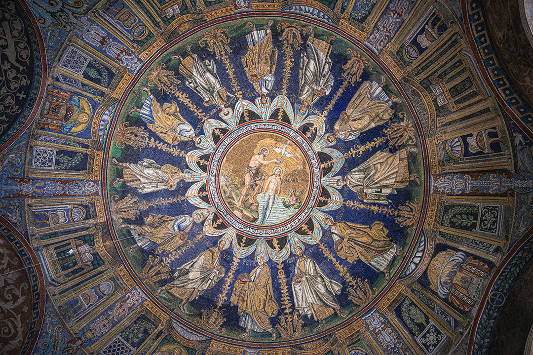 An ornate ceiling mosaic depicting the baptism of Christ and the apostles inside the Baptistery of Neon in Ravenna.