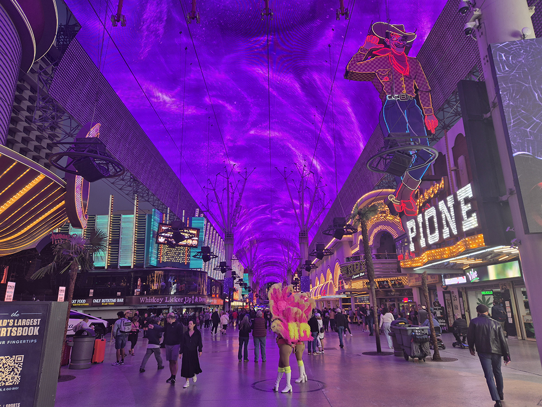 Fremont Street Experience in downtown Las Vegas, featuring neon lights, street performances and a vibrant LED canopy atmosphere.