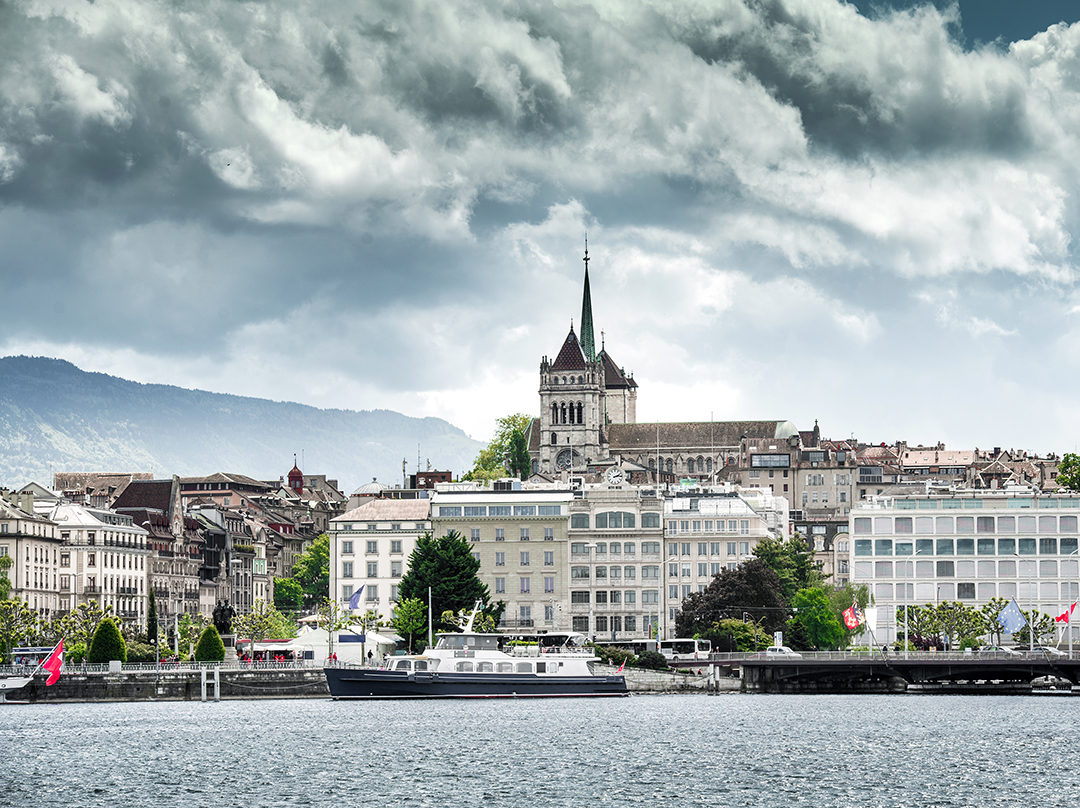 View of Geneva along Lake Geneva with historic architecture and the Alps in the background, reflecting the elegant character of Switzerland’s international city.