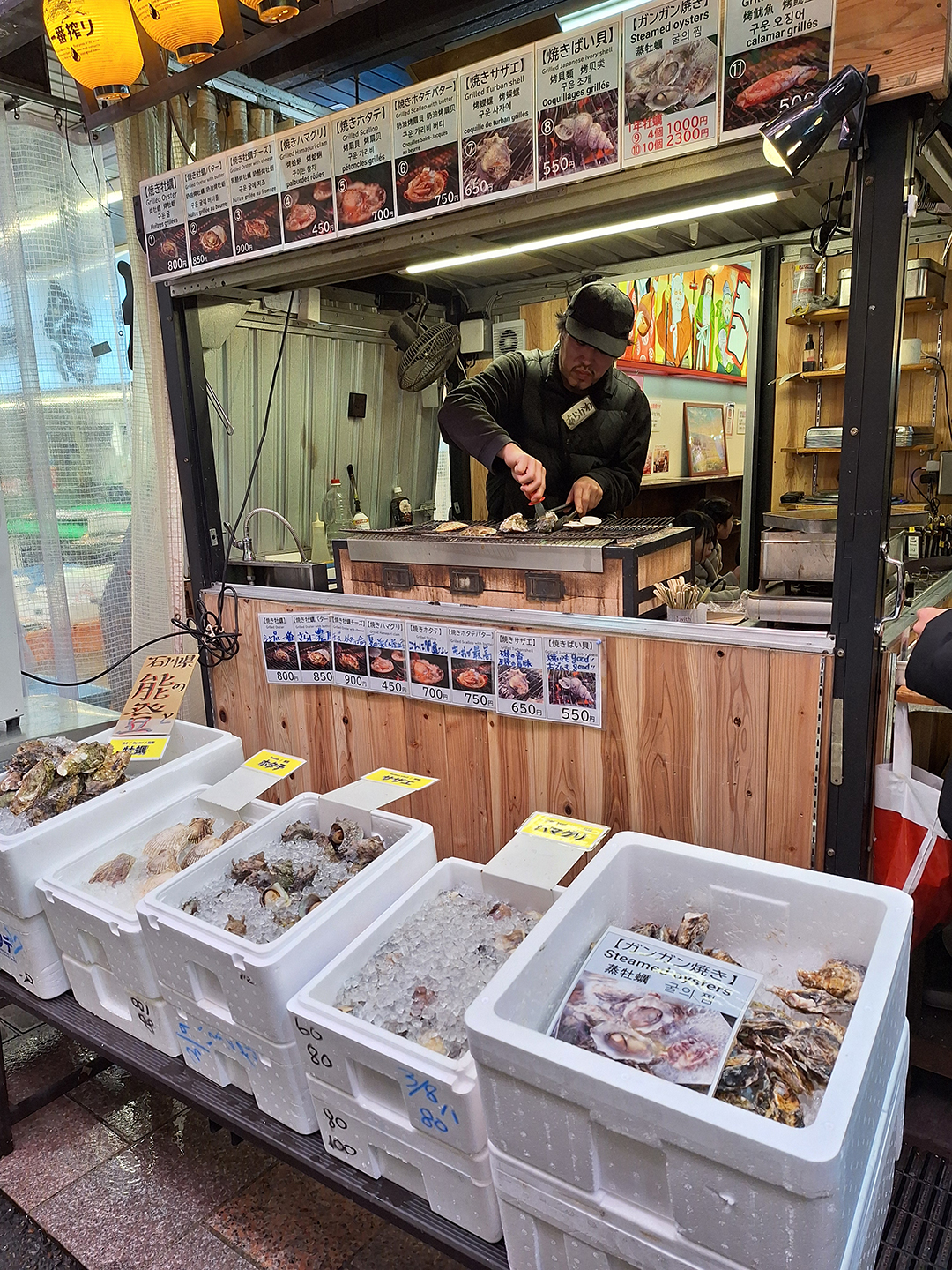Sveže morske dobrote na tržnici Omicho Market razkrivajo kulinarični utrip Kanazawe, kjer obiskovalci okušajo lokalne specialitete, pripravljene neposredno pred njihovimi očmi.